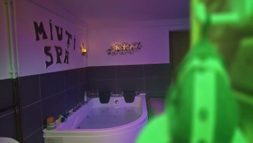 a purple bathroom with a tub and a sink at Miuti Residence in Triberg