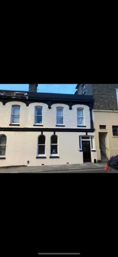 a large white building with windows on a street at Victorian Town House in the Heart of Dover in Dover