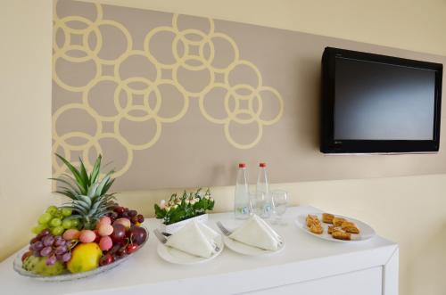 a table with a bowl of fruit and a tv at Ruth Daniel Residence in Tel Aviv