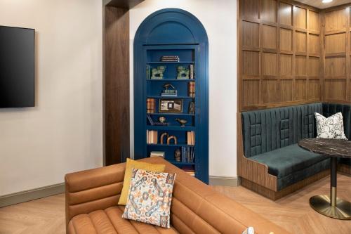 a living room with a couch and a book shelf at The Ansonborough in Charleston