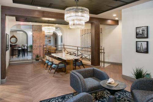 a dining room and living room with a table and chairs at The Ansonborough in Charleston