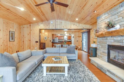 a living room with a couch and a fireplace at Beautiful Breezy Point Home with Beach and Dock! in Pequot Lakes