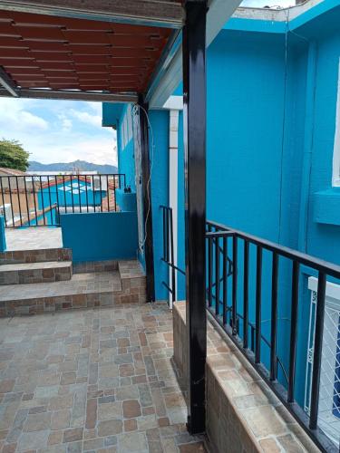 a view from the balcony of a blue building at Hostal primaveras habitación 1 in Santa Ana