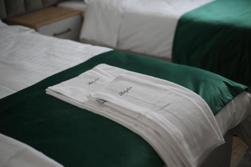 a white shirt sitting on top of a bed at Camere de inchiriat Adyden in Arbore