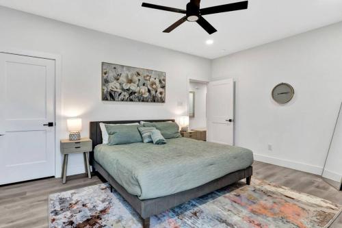 a bedroom with a bed and a ceiling fan at Perfect Dallas Oasis l Pet Friendly l Big Backyard in Oldham
