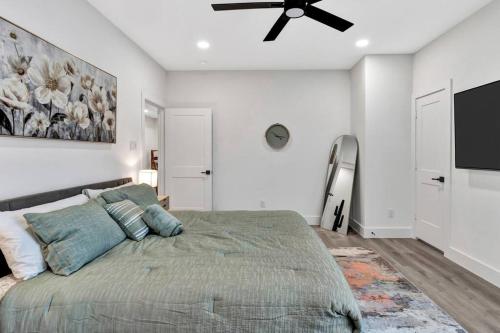 a bedroom with a bed and a ceiling fan at Perfect Dallas Oasis l Pet Friendly l Big Backyard in Oldham