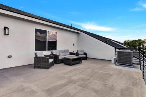 a patio with a couch and chairs on a roof at Perfect Dallas Oasis l Pet Friendly l Big Backyard in Oldham