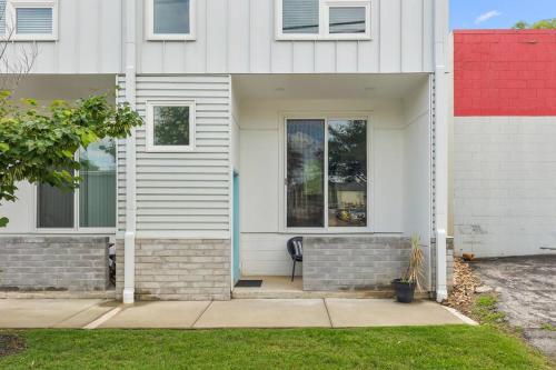a white house with a bench in front of it at South Side Modern - Downtown Living - Amazing Location in Chattanooga