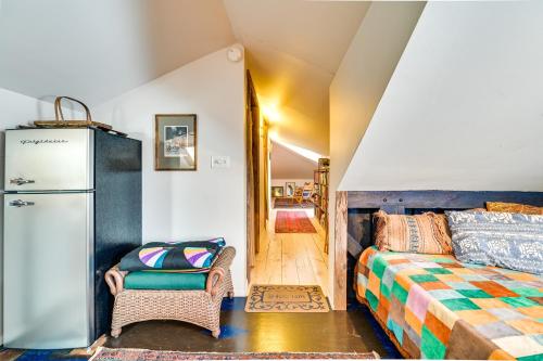 a bedroom with a bed and a refrigerator at Cozy Catskills Vacation Rental with Deck! in Fleischmanns
