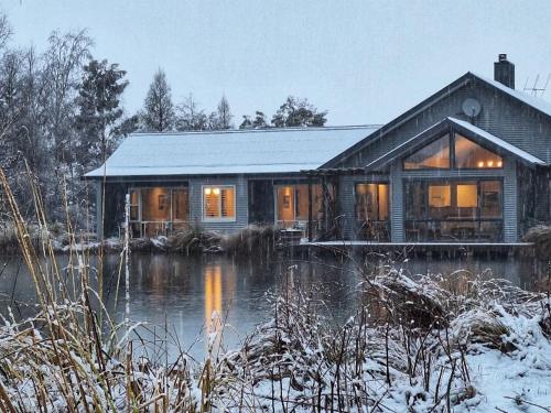 a house on a river in the snow at Matuka Lodge in Twizel