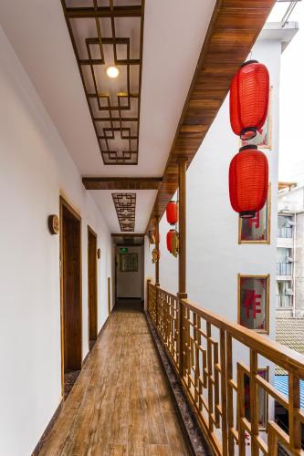 a hallway with wooden floors and red lanterns at Zhangjiajie Jijiehao Inn in Zhangjiajie