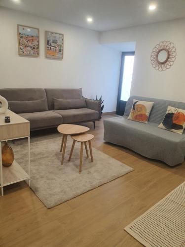 a living room with a couch and a table at Charming Jasmin House in Viseu