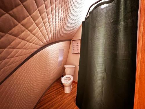 a small bathroom with a toilet in a small room at Sunken Escapes Glamping Unit #1 in New Minas