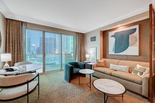a living room with a couch and a table at Amethyst Studio Suite MGM Signature STRIP VIEW Balcony in Las Vegas