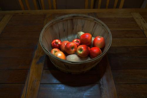 a basket of apples sitting on a table at Pine Hills Cabin in Julian in Julian