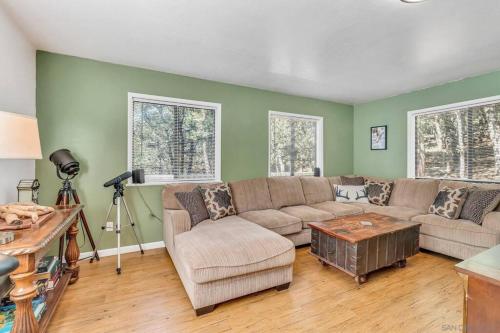 a living room with a couch and a table at Pine Hills Cabin in Julian in Julian