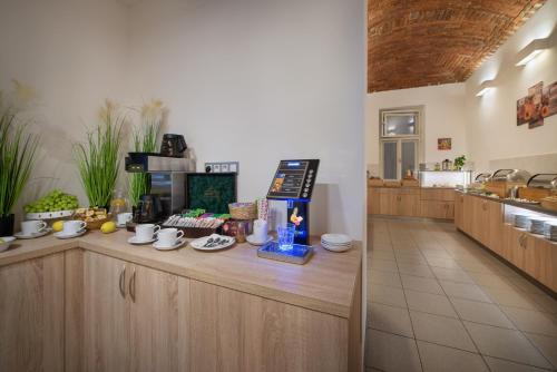a kitchen with a counter with food on it at Prague Season Hotel in Prague