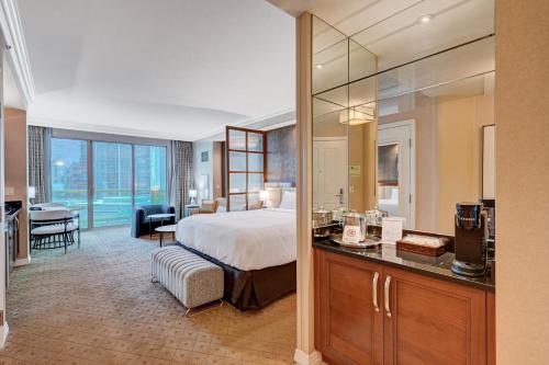 a hotel room with a bed and a bathroom at Amethyst Suite II Balcony STRIP VIEW MGM Signature in Las Vegas