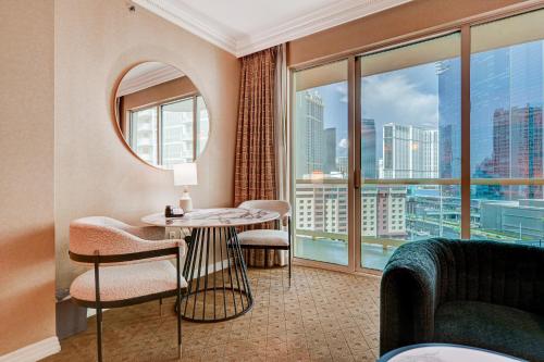 a living room with a table and chairs and a large window at Amethyst Suite II Balcony STRIP VIEW MGM Signature in Las Vegas