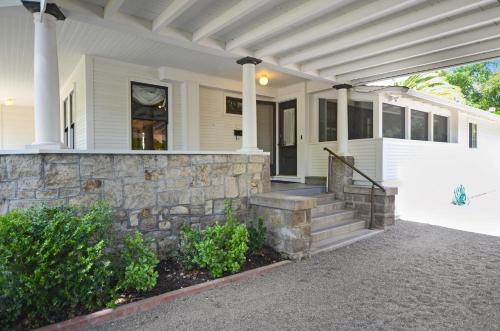 a white house with a stone wall and stairs at Sonoma Victorian In Heart Of Sonoma in Sonoma