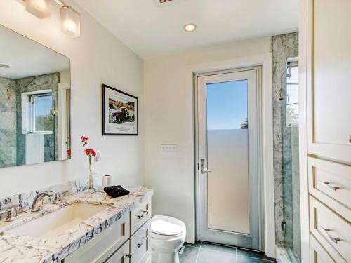 a bathroom with a sink and a toilet and a mirror at Sonoma-Napa Wine Country Retreat Surrounded By Vineyards, Views, & Privacy in Sonoma