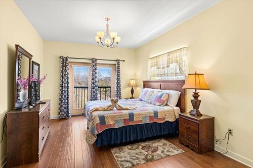 a bedroom with a bed and a dresser and a window at Vacation Destination in Pigeon Forge