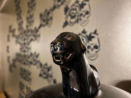 a black cat statue sitting on top of a plate at VILLA Philipp Plein - Designervilla mit Pool & SPA in Amriswil