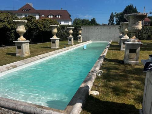 a swimming pool with turquoise water in a yard at VILLA Philipp Plein - Designervilla mit Pool & SPA in Amriswil