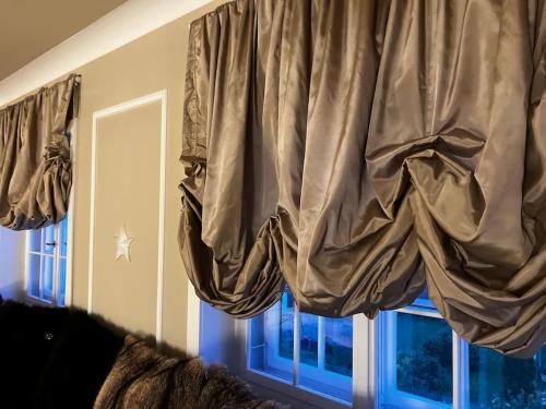 a curtain in a room with a window at VILLA Philipp Plein - Designervilla mit Pool & SPA in Amriswil