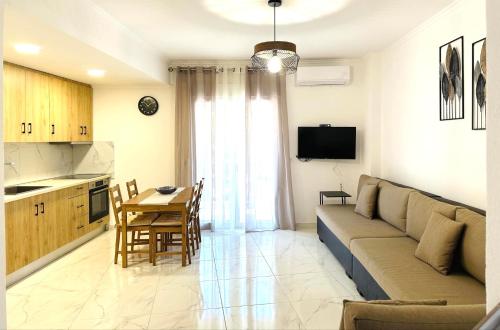 a living room with a couch and a table at Jasmin Apartments in Hanioti