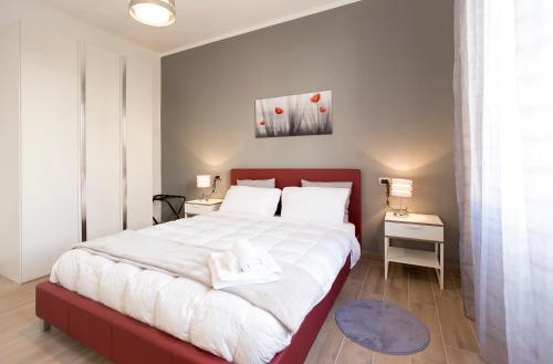 a bedroom with a large bed with a red headboard at Antale in Alghero
