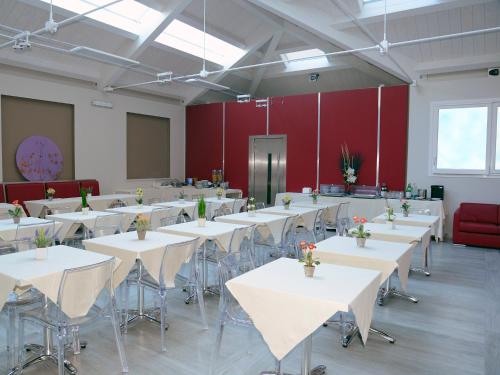 a large room with white tables and chairs at Hotel Giotto in Turin