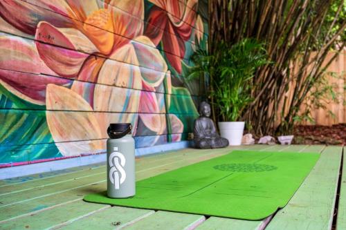 a water bottle sitting on a table in front of a wall at The Gallery at Duckpond - 1930s Historic Charm in Gainesville