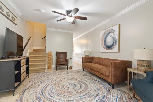 a living room with a couch and a ceiling fan at Downtown Ocean Springs Townhouse 3 bedrooms in Ocean Springs