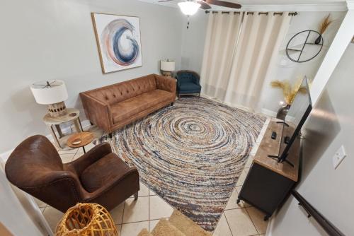 a living room with a couch and a rug at Downtown Ocean Springs Townhouse 3 bedrooms in Ocean Springs