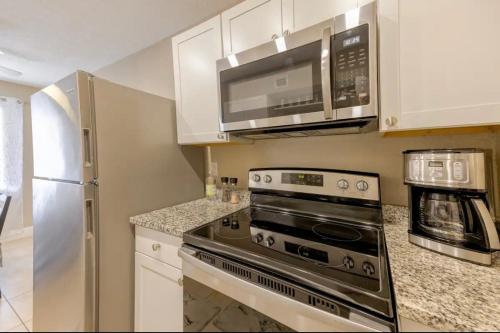 a kitchen with a stove and a microwave at Beautiful apartment in Naples in Naples