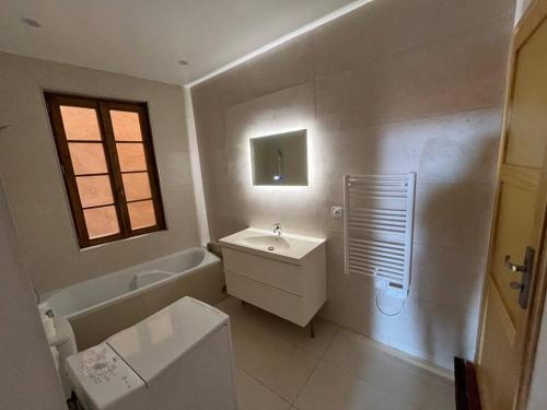 a bathroom with a sink and a tub and a toilet at Place aux Aires in Grasse