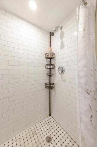 a bathroom with a shower with a black and white tiles at Beautiful apartment in Naples in Naples