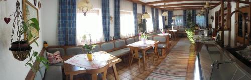 a restaurant with tables and chairs in a room at Jörghof in Bad Kleinkirchheim