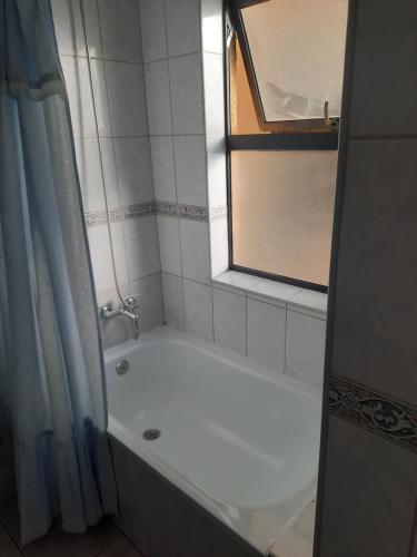 a white bath tub in a bathroom with a window at Departamento en Pucón in Pucón