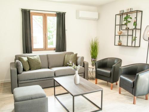 a living room with a couch and two chairs at Lac Bleu 16 in Lacapelle-Marival