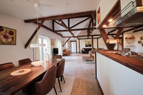 a kitchen and living room with a long table and chairs at Askegaarden Apartments in Sandved