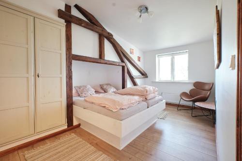 a bedroom with a bed with a wooden frame at Askegaarden Apartments in Sandved