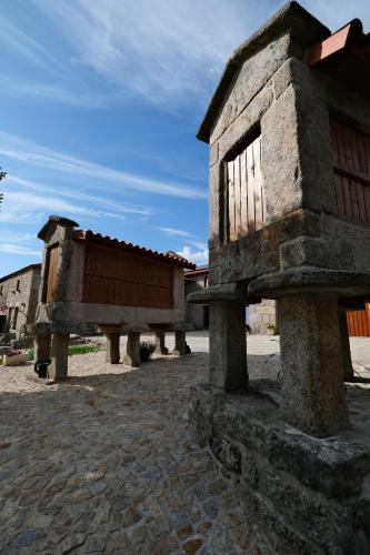 a stone building with a window on a street at JADS Guesthouse in Fafião