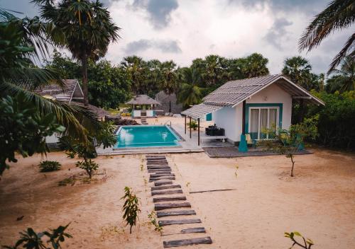 a house on the beach with a swimming pool at Bedrock Beach Villas in Kalpitiya