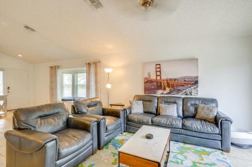 a living room with two leather couches and a table at 30 Mi to Universal Epic Universe Golf Club Villa in Haines City