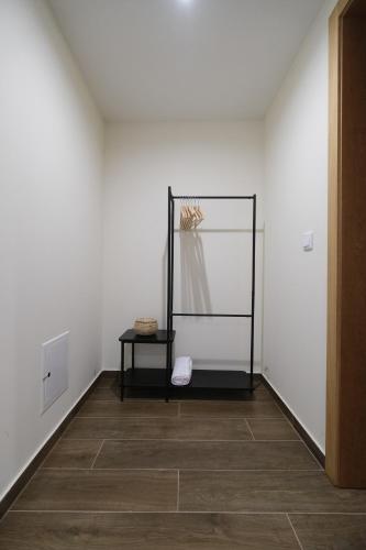 a white room with a mirror and a table at JADS Guesthouse in Fafião