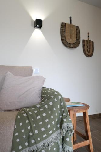 a room with a couch and a table with a lamp at JADS Guesthouse in Fafião