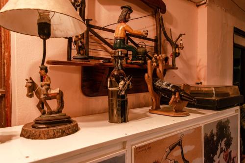 Un estante con una lámpara y algunas figuras encima. en Dpto a 4 min del Shopping y Centro de Convenciones, en Corrientes