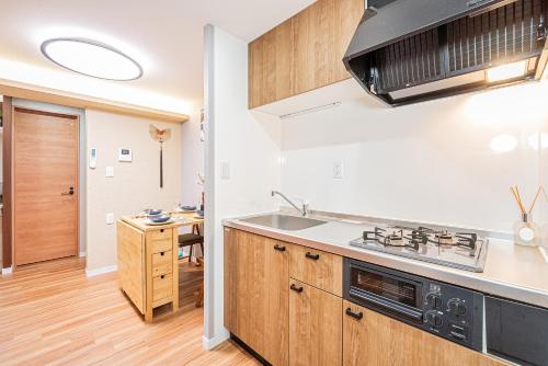 a kitchen with a sink and a stove at Ueno Park Asakusa Temple Ueno Family Inn in Tokyo